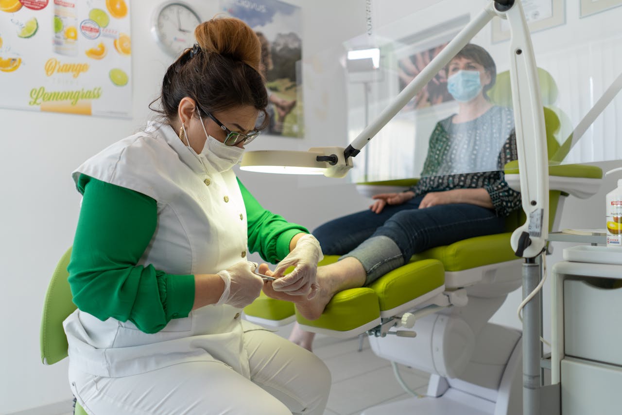 who-we-are-01 A beautician provides a pedicure in a modern spa setting, focusing on foot care and relaxation.